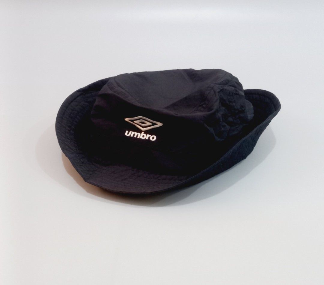 Umbro Black Bucket Hat (Category: Caps & Hats) located in Cebu City. Submitted by MrLiks_123 (Listing ID 1465588763, Image 3). Description: - Brand: Umbro - Color: Black with white embroidered logo - Style: Classic sporty bucket hat / streetwear - Features: Lightweight material and adjustable strap with small logo tag - Fit: Comfortable, fits most head sizes - Condition: Brand new / excellent.