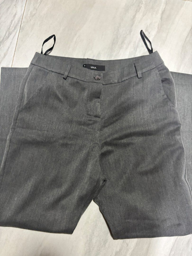 UNA Grey Formal Pants Size M (Category: Other Bottoms) located in Manila. Submitted by maeann.nv (Listing ID 1465711946, Image 1). Description: - Brand: UNA - Size: M (tag near waistband) - Color/Material: Clean heather grey, minimal wrinkling - Features: Front button closure, belt loops, side pockets - Condition/Style: Great staple piece for office wear or smart casual outfits.