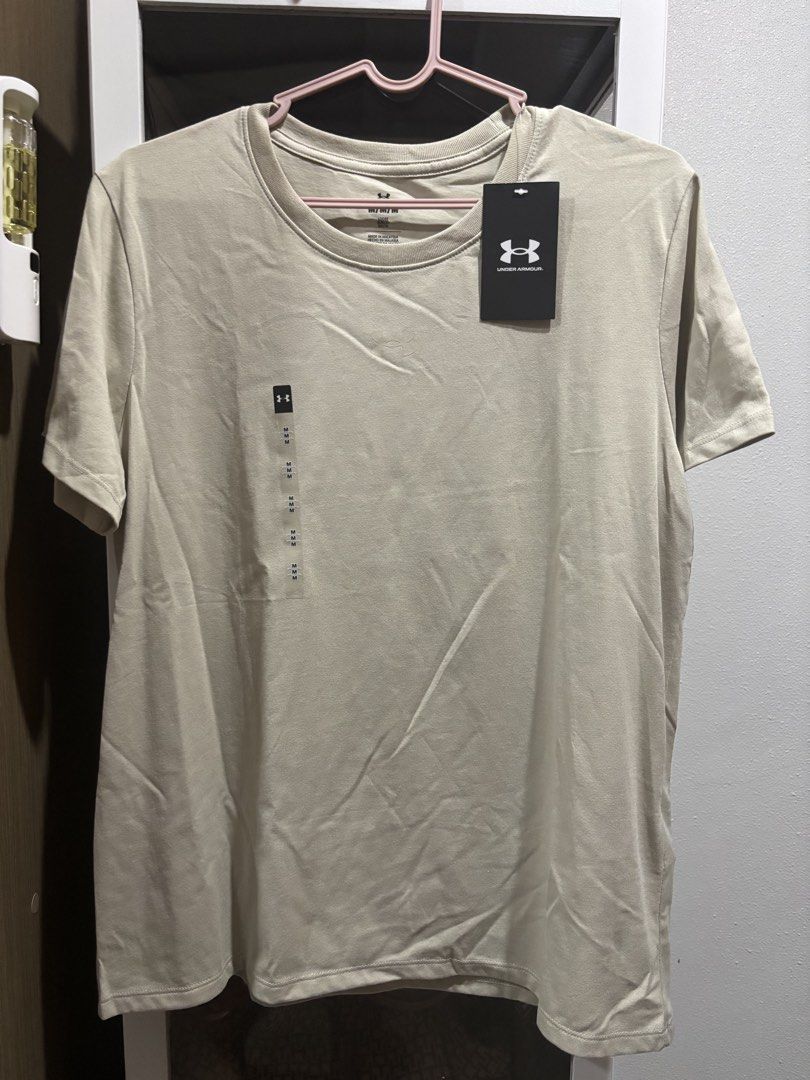 Under Armour Beige T-shirt Size M (Category: Shirts) located in San Pablo. Submitted by loved.goods0501 (Listing ID 1465638223, Image 1). Description: Origin: HongKong 100% authentic and ready to ship Brand: Under Armour Color: Beige with subtle tonal embroidered logo Size/Fit: Loose fit, short sleeves, crew neck Condition: Brand new with original paper tags attached, never worn 💵 gcash/bank.