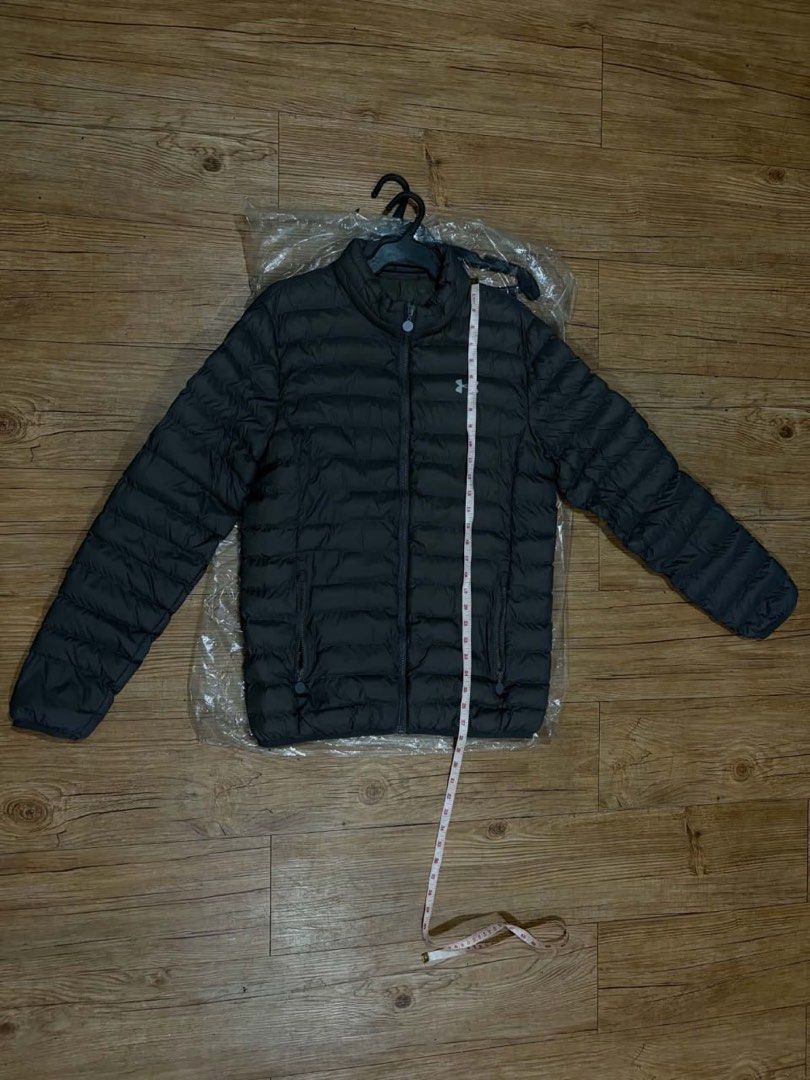 Under Armour Puffer Jacket Dark Grey (Category: Coats, Jackets and Outerwear) located in Mandaluyong City. Submitted by zaiampiloquio (Listing ID 1465608453, Image 3). Description: - Brand: Under Armour - Color: Dark grey with small white logo - Style: Quilted puffer jacket with full zip and high collar - Pockets: Convenient side zip pockets - Measurements: ~22" chest across, ~27" length top to bottom - Condition: Clean and ready to wear.