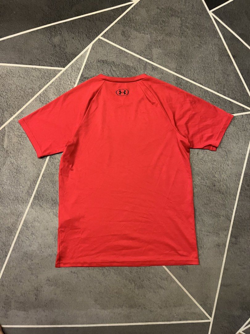 Under Armour Red Athletic T-Shirt (Category: Tshirts & Polo Shirts ) located in Manila. Submitted by silvertree-31cc (Listing ID 1465727340, Image 2). Description: - Brand: Under Armour - Color: Bright red with large black chest logo and small back neckline print - Fit: Standard fit, short sleeves, crew neck - Material: Breathable athletic fabric - Ideal for: Workouts, running, or casual daily wear.