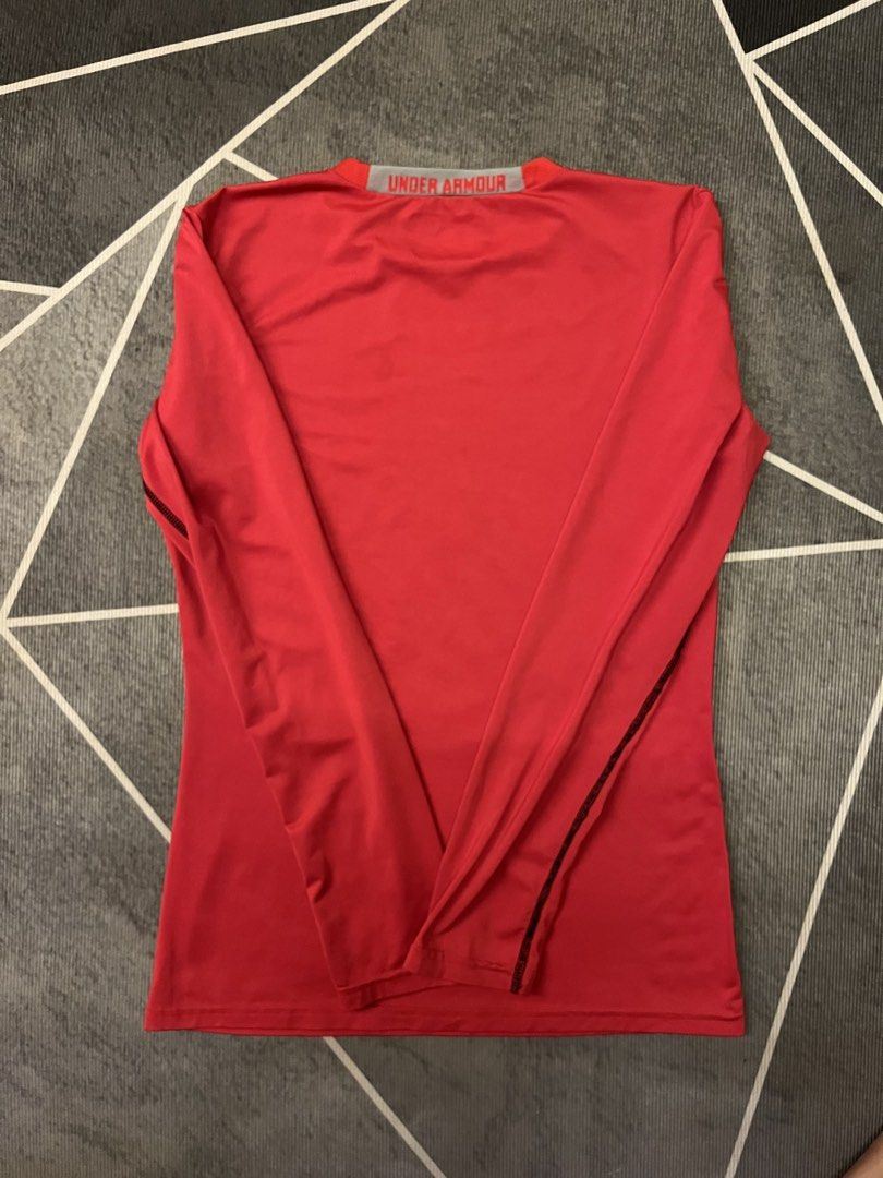 Under Armour Red Long Sleeve Athletic Shirt (Category: Activewear) located in Manila. Submitted by silvertree-31cc (Listing ID 1465727504, Image 2). Description: - Brand: Under Armour - Color: Red with black logo on chest and text on back collar - Fit/Style: Crew neck long sleeve athletic top with contrast stitching - Sun Protection: Built-in UPF 50+ - Material: Lightweight and breathable - Ideal For: Workouts, running, and outdoor sports - Condi