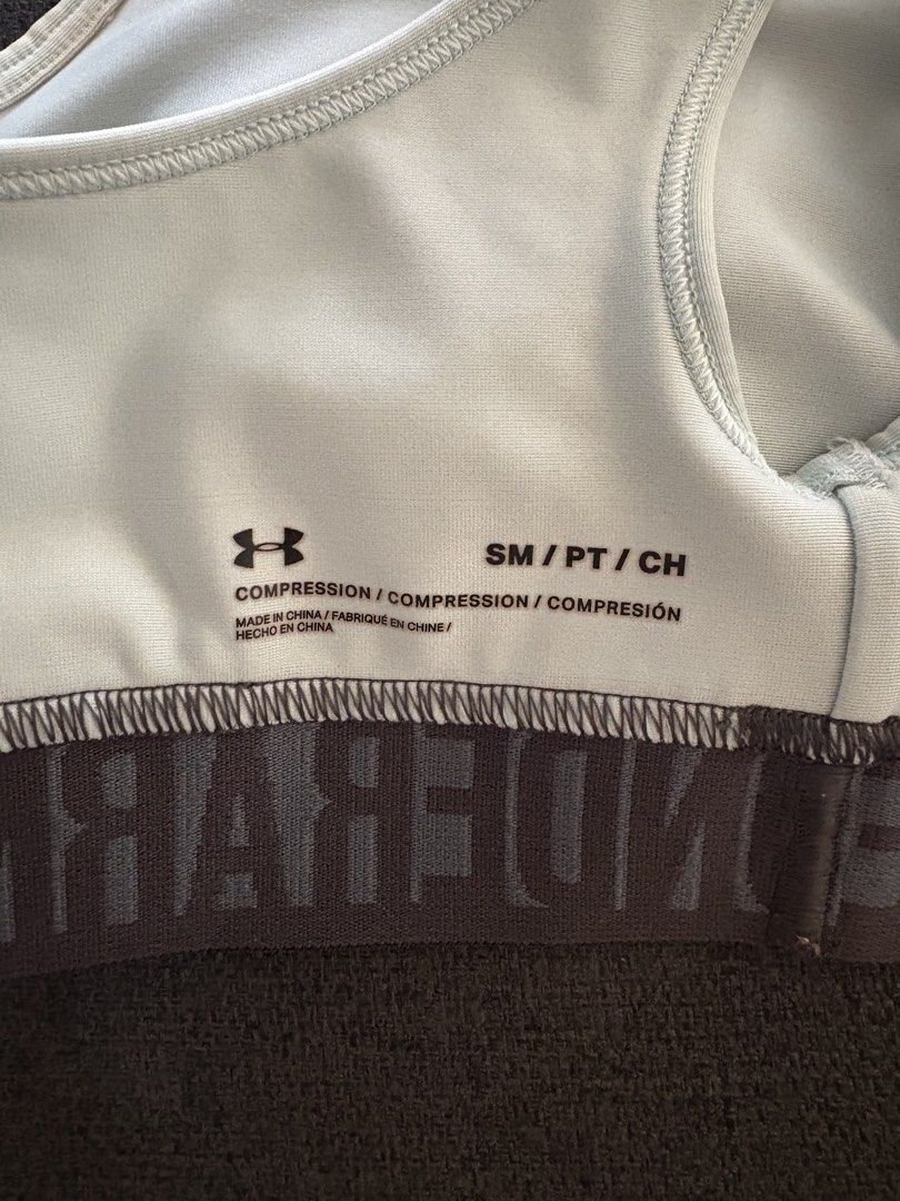 Under Armour Sports Bra Light Blue (Category: Activewear) located in Quezon City. Submitted by hannahhhhssclosetttt (Listing ID 1465627248, Image 3). Description: - Brand: Under Armour - Size: Small (Compression fit) - Color: Light blue with dark grey branded band - Design: Crossback straps with open keyhole back detail - light stain on the left ( last pic ) - rfs does not fit me anymore.