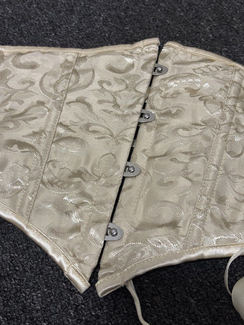 Underbust Corset (Category: Sleeveless) located in Muntinlupa City. Submitted by angeliqvn (Listing ID 1465738515, Image 3). Description: Perfect for Halloween - Style: Underbust corset with a chic floral damask pattern - Closure: Front metal busk with four silver clasps - Support: Structured vertical boning panels on front and sides - Design: Curved top edge and flattering dipped hemline - Material: Heavy fabric with a subtle sheen - Condition: 