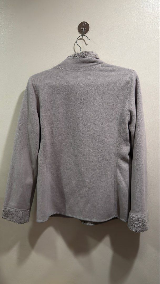 Uniqlo Reversible Fleece Jacket (Category: Coats, Jackets and Outerwear) located in Cebu City. Submitted by ngl.prelovedstuff (Listing ID 1465602136, Image 3). Description: This item is a Uniqlo Reversible Fleece Jacket in grey. It features a plush, high-pile teddy or boa fleece on one side with characteristic curved front patch pockets, a high stand collar, and a full-zip front closure. The interior consists of a smoother, standard microfleece l