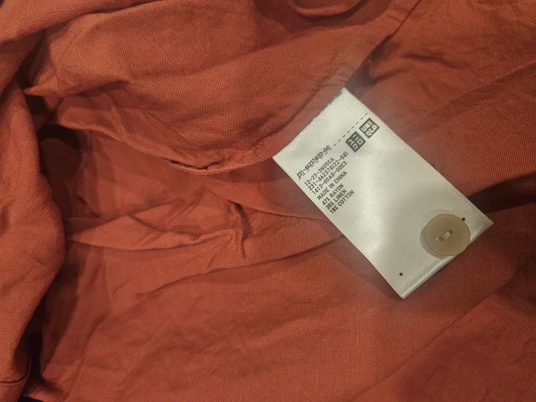 Uniqlo Short Sleeve Blouse (Category: Blouses) located in Muntinlupa City. Submitted by aremvy (Listing ID 1465630800, Image 3). Description: Preloved Uniqlo Short sleeve button-down shirt - Color: Rusty Orange - Size: S - Material: 47% Rayon, 35% Linen, 18% Cotton - Details: White front buttons, collar neck design - Condition: Excellent .