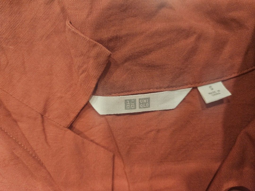 Uniqlo Short Sleeve Blouse (Category: Blouses) located in Muntinlupa City. Submitted by aremvy (Listing ID 1465630800, Image 2). Description: Preloved Uniqlo Short sleeve button-down shirt - Color: Rusty Orange - Size: S - Material: 47% Rayon, 35% Linen, 18% Cotton - Details: White front buttons, collar neck design - Condition: Excellent .