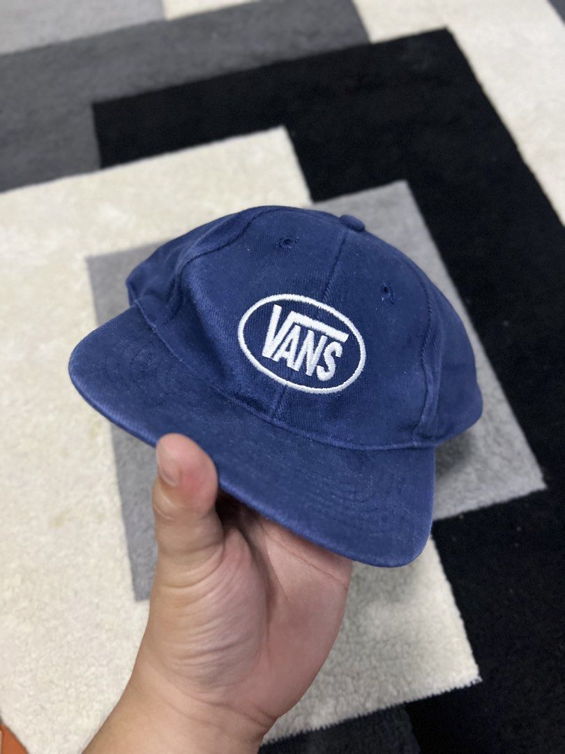 Vans Blue Oval Logo Snapback Cap (Category: Caps & Hats) located in Calasiao. Submitted by pb.supply_v2 (Listing ID 1465752532, Image 3). Description: - Brand: Vans - Color: Classic Navy Blue with white embroidered oval logo - Design: Six-panel unstructured build with metal eyelets for breathability - Fit: Adjustable snapback closure for a custom fit - Style: Versatile everyday casual streetwear.