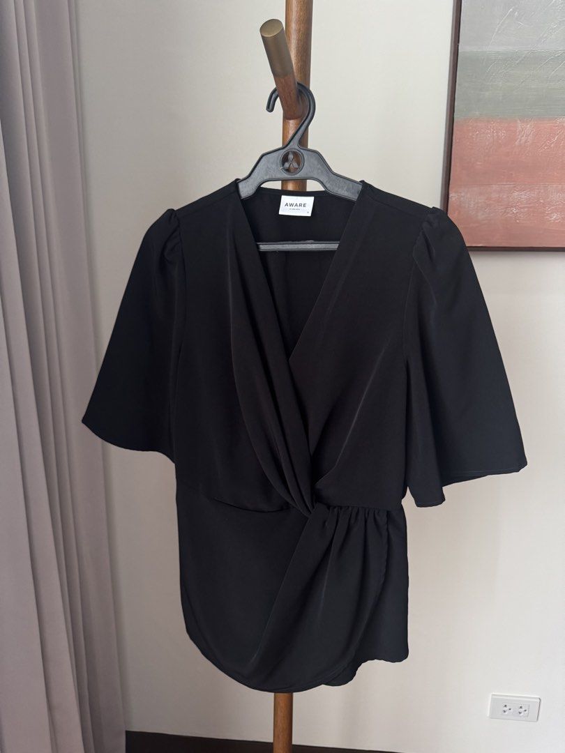 Vero Moda Black Wrap Blouse (Category: Blouses) located in Pasig City. Submitted by kutleyn (Listing ID 1465657313, Image 1). Description: - Brand: Aware by Vero Moda - Size: Small - Color: Classic Black - Design: V-neck with twisted front knot detail - Sleeves: Puffed short sleeves with gathered shoulders - Material: Smooth, comfortable fabric - Versatile: Great for work, dates, or casual days out - Easy to style: Looks great with trousers, jean