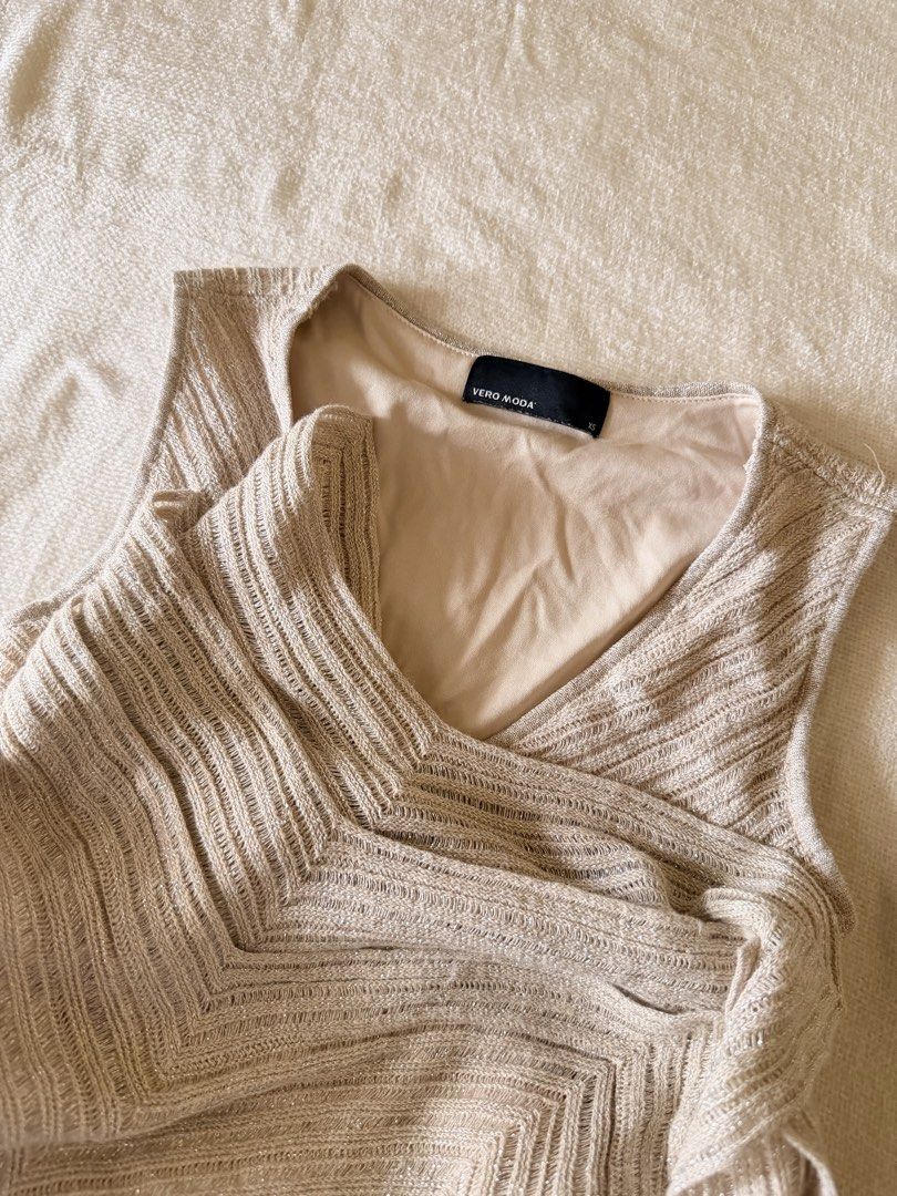 Vero Moda Knit Glittery Dress (Category: Dresses) located in Iloilo. Submitted by hellodindi (Listing ID 1465680153, Image 2). Description: - Brand: Vero Moda - Size: XS (tag attached) can fit up to Semi M - Color/Fabric: Metallic gold knit with subtle sparkle, fully lined in nude beige - Design: Sleeveless, V-neckline, fitted ribbed waist, and flared hem with chevron patterns.