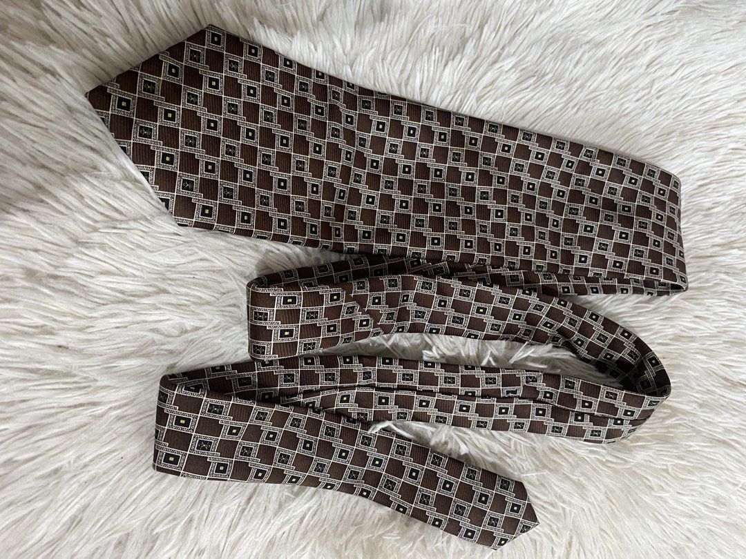 Victor Laurent 100% Silk Brown Geometric Tie (Category: Ties) located in Bulacan. Submitted by rich2545 (Listing ID 1465581293, Image 1). Description: - Brand: Victor Laurent - Material: 100% Soie Silk (Handmade finish) - Design: Brown with geometric gold and white square details - Width: Standard - Condition/Details: Clean lining on the back - Ideal for: Work, meetings, or formal events.