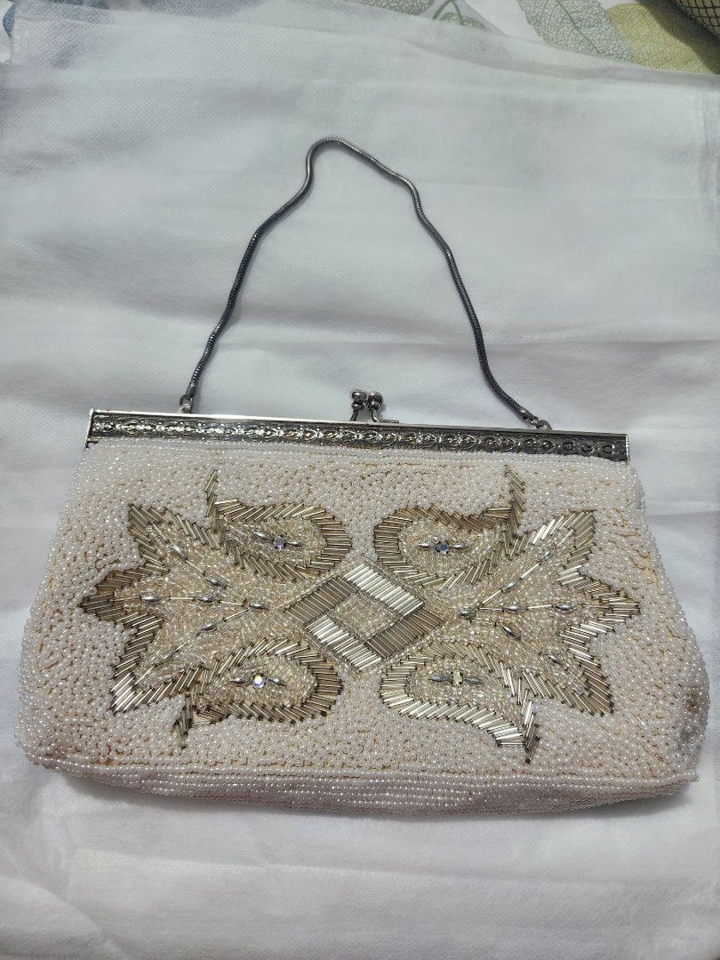 Vintage Beaded Evening Clutch Bag With Chain Strap (Category: Clutches) located in Quezon City. Submitted by mmstorres042181 (Listing ID 1465671410, Image 1). Description: - Colour: Cream - Material: Heavy bugle beadwork with rhinestone accents - Hardware: Silver-tone frame and clasp with tiny iridescent stones - Strap: Thin snake chain (can be tucked inside or worn over the shoulder) - Interior: Lined with a convenient slip pocket - Closure: Cla