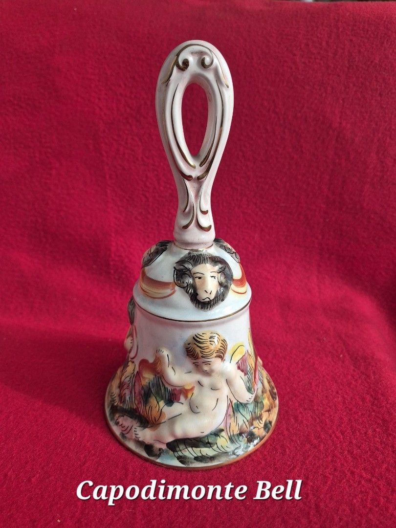 Vintage Capodimonte Bell (Category: Vintage Collectibles) located in Makati City. Submitted by maydeleo1 (Listing ID 1465582132, Image 1). Description: Vintage Capodimonte Porcelain Bell (Made in Italy) – Pristine Condition Price: ₱2,200 Beautiful authentic vintage Italian Capodimonte porcelain hand bell measuring 8.5 inches tall.Features elegant raised 3D detailing of cherubs and classic ram heads with gold gilt accents. Condition: Pristine / Li