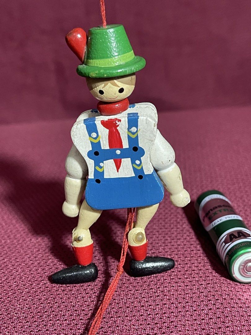 vintage Jumping Jack toy,(Hampelmann) (Category: Interactive Toys) located in Manila. Submitted by dstrangerthings (Listing ID 1465673938, Image 1). Description: This is a traditional German wooden Jumping Jack toy, also known as a Hampelmann. It is a jointed flat wooden figure with a pull string at the bottom. When the string is pulled, the figure’s arms and legs move up and down, making it “jump”. The toy is hand-painted and often used as a han