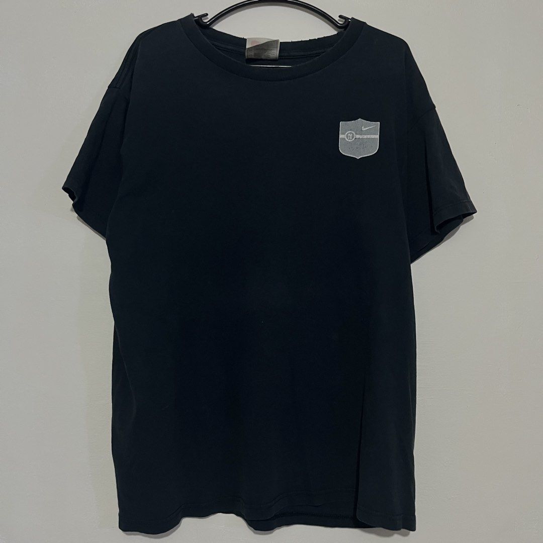 Vintage Nike Athletics Courage Commitment Challenge T-Shirt (Category: Tshirts & Polo Shirts ) located in Caloocan City. Submitted by thrivo.co (Listing ID 1465633518, Image 1). Description: - Brand: Nike - Style: Vintage Nike Athletics t-shirt - Color: Black - Size: Medium (Classic red Nike swoosh tag) - Front: Distressed shield graphic - Back: Bold 'NIKE ATHLETICS COURAGE COMMITMENT CHALLENGE' lettering with swoosh - Condition: Soft fabric with