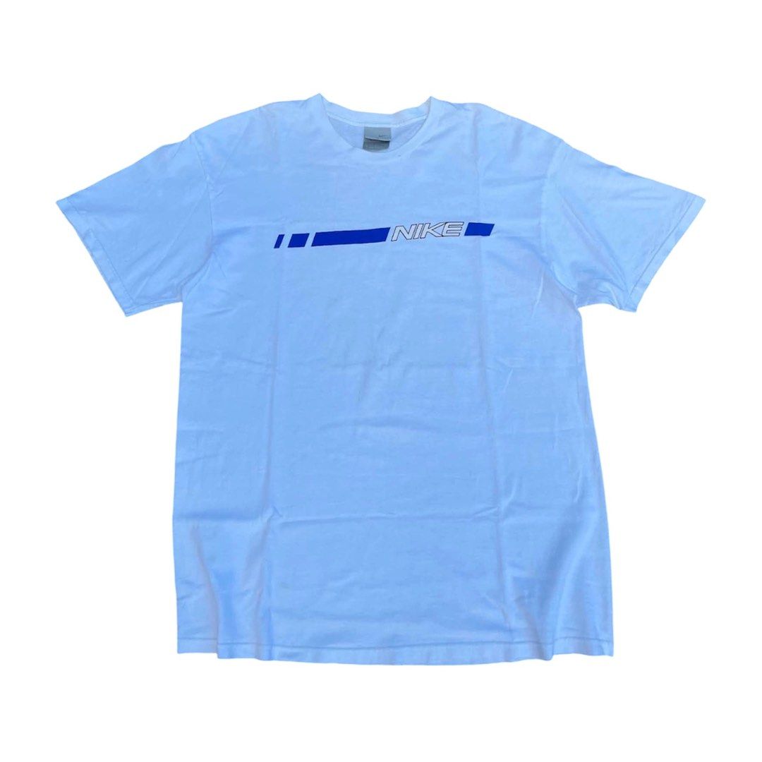 Vintage Nike White Blue Graphic Tee (Category: Tshirts & Polo Shirts ) located in Calabanga. Submitted by 4405.curator (Listing ID 1465594463, Image 1). Description: White Nike t-shirt with a blue graphic stripe and bold logo across the chest. Crew neckline, short sleeves. Size XL, made in Mexico. Classic retro look from the silver tag era. Got a few tiny faint marks near the front graphic stripe, check the close-up photo. Fabric feels well-worn 