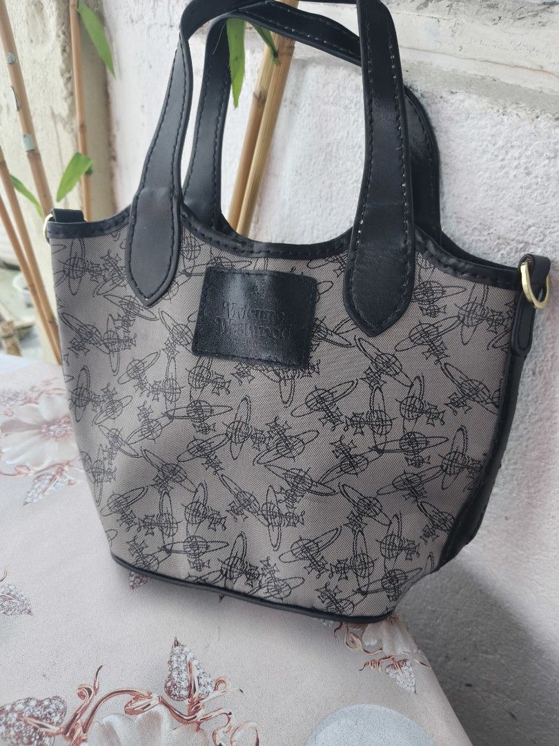 Vivienne Westwood Patterned Tote Handbag (Category: Luxury Bags & Wallets) located in Binan City. Submitted by makinpeso0622 (Listing ID 1465756647, Image 1). Description: - Brand: Vivienne Westwood - Design: All-over orb logo pattern in grey canvas with black faux leather trim - Details: Gold-tone side hardware rings and black leather 'Made in Italy' stamped logo patch - Handles: Dual top handles with structured everyday shape - Condition: Clean