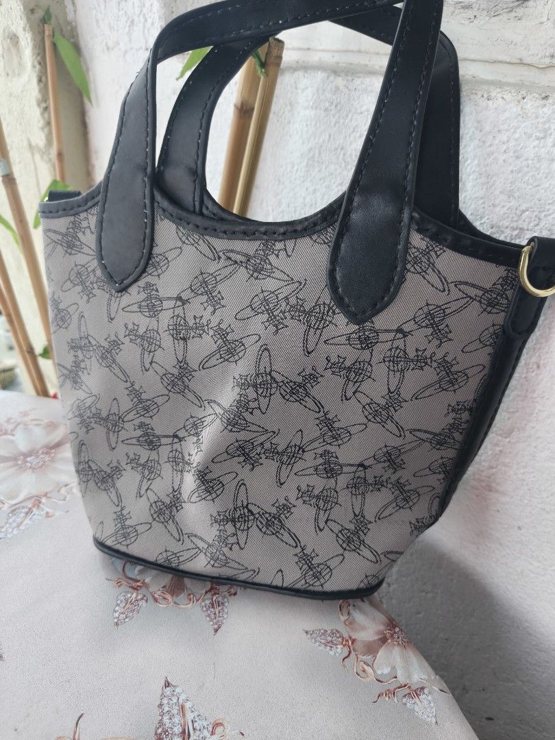 Vivienne Westwood Patterned Tote Handbag (Category: Luxury Bags & Wallets) located in Binan City. Submitted by makinpeso0622 (Listing ID 1465756647, Image 2). Description: - Brand: Vivienne Westwood - Design: All-over orb logo pattern in grey canvas with black faux leather trim - Details: Gold-tone side hardware rings and black leather 'Made in Italy' stamped logo patch - Handles: Dual top handles with structured everyday shape - Condition: Clean