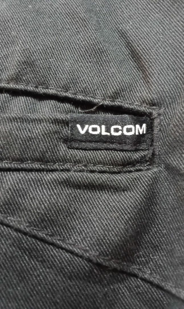 Volcom Black Shorts Size 36 (Category: Shorts) located in Caloocan City. Submitted by lourdma (Listing ID 1465636648, Image 2). Description: - Brand: Volcom - Size: 36 - Color: Solid black - Material: Eco-friendly Repreve recycled fabric - Closure: Button waist with branded metal hardware - Pockets: Back welt pockets with small Volcom logo tag - Condition: Clean and well-maintained.