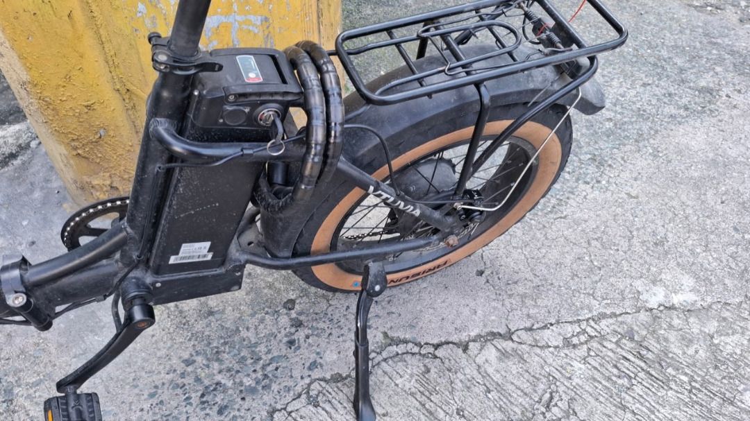 VTUVIA SF20 Foldable Step-Thru Electric Bike (Category: Bicycles) located in Manila. Submitted by sellingmystuffhere (Listing ID 1465637932, Image 3). Description: - Model: EV-SF20 Folding Electric Bike - This is not the updated SF20H variant - Color: Black with 20" x 4.0" fat tires (with stylish tan sidewalls) - Features: Front suspension fork, rear cargo rack, mudguards, and handlebar display computer - Front suspension is stuck, due to manual 
