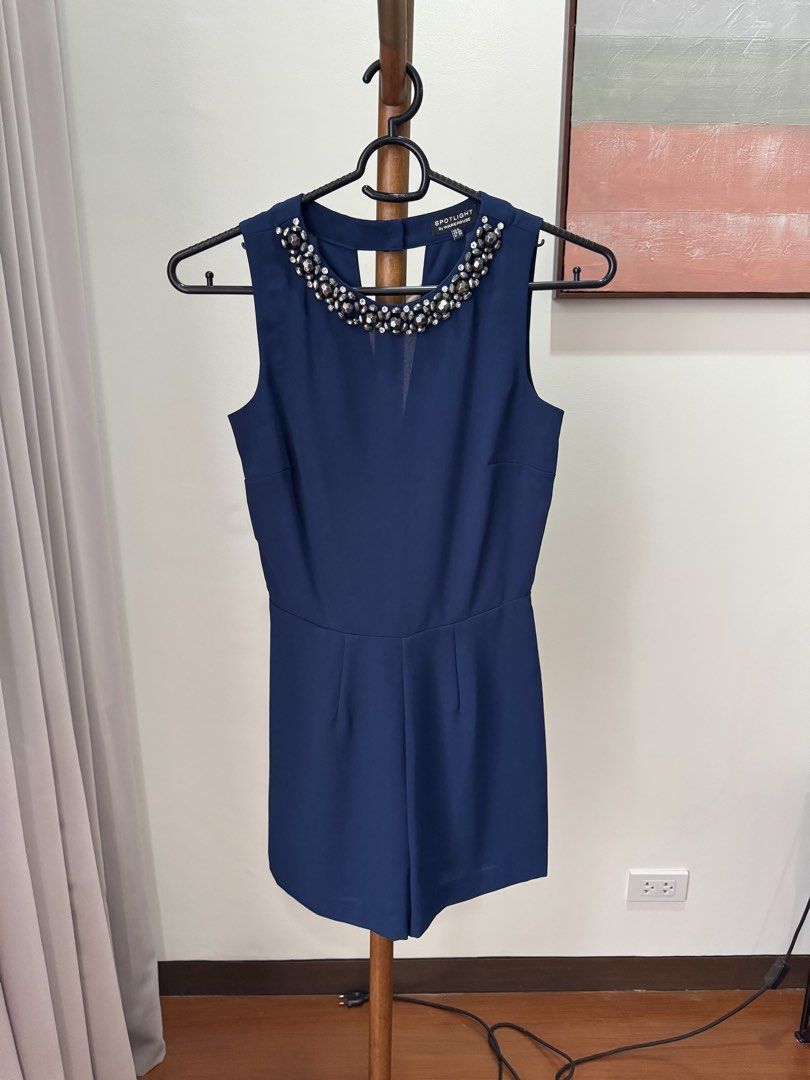 Warehouse Navy Blue Embellished Romper UK 8 (Category: Rompers) located in Pasig City. Submitted by kutleyn (Listing ID 1465759592, Image 1). Description: - Brand: Spotlight by Warehouse - Style: Sleeveless romper / playsuit in deep navy blue - Size: UK 8 (FR 36, D 34) - Details: Heavy rhinestone and metal bead neckline embellishment, pleated front shorts, keyhole back with button, and back zip closure - Occasion: Ideal for evening wear, parties,