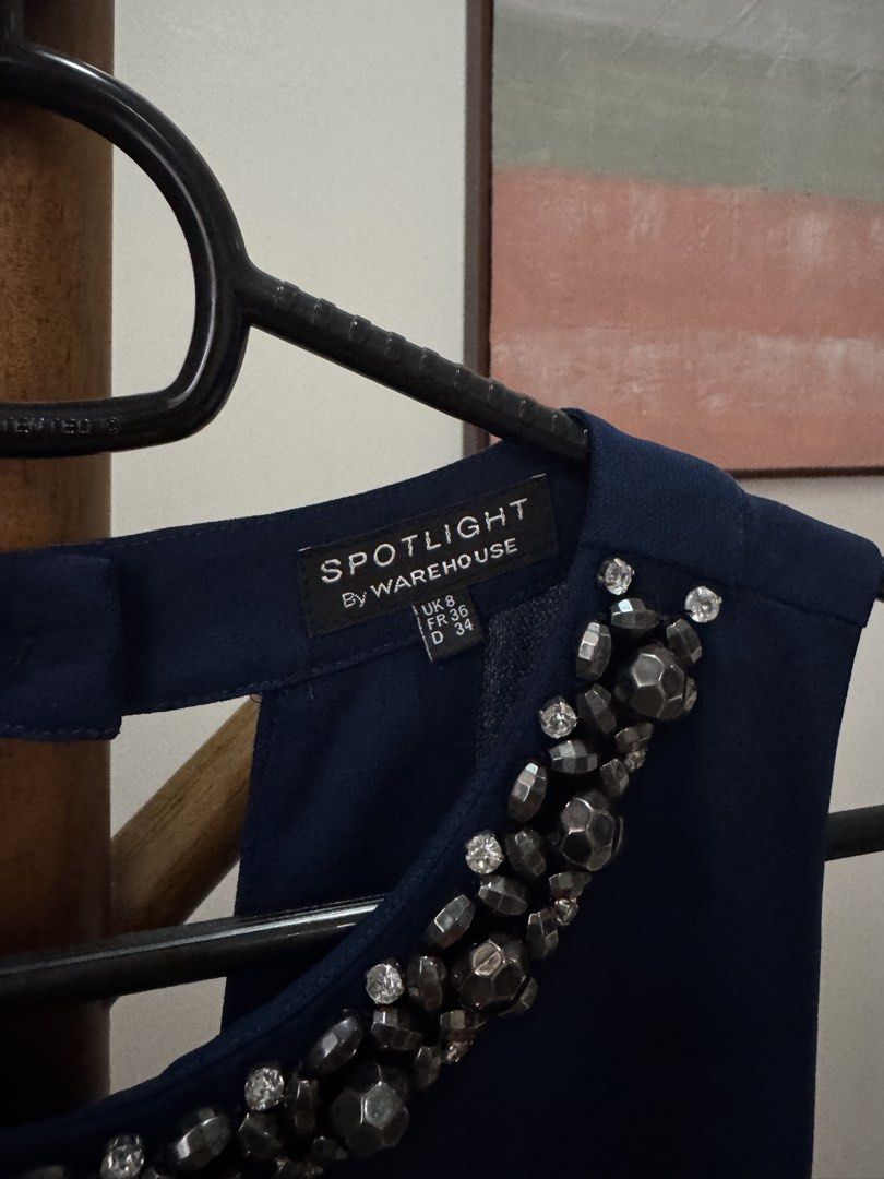 Warehouse Navy Blue Embellished Romper UK 8 (Category: Rompers) located in Pasig City. Submitted by kutleyn (Listing ID 1465759592, Image 2). Description: - Brand: Spotlight by Warehouse - Style: Sleeveless romper / playsuit in deep navy blue - Size: UK 8 (FR 36, D 34) - Details: Heavy rhinestone and metal bead neckline embellishment, pleated front shorts, keyhole back with button, and back zip closure - Occasion: Ideal for evening wear, parties,