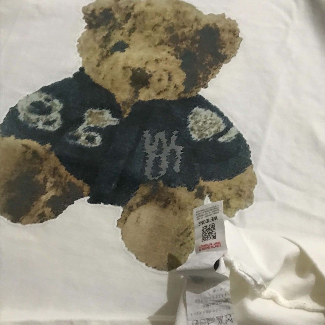 We11done Bear Graphic White T-Shirt (Category: Shirts) located in Manila. Submitted by its_d4ve (Listing ID 1465687756, Image 3). Description: - Brand: We11done - Color: White - Style: Short sleeve crewneck t-shirt - Design: Large teddy bear graphic printed on front and back - Details: Branded collar tag and signature black rubber logo patch near the hem - Material: Premium soft cotton - Condition: Brand new with tag attached, includes QR code fo