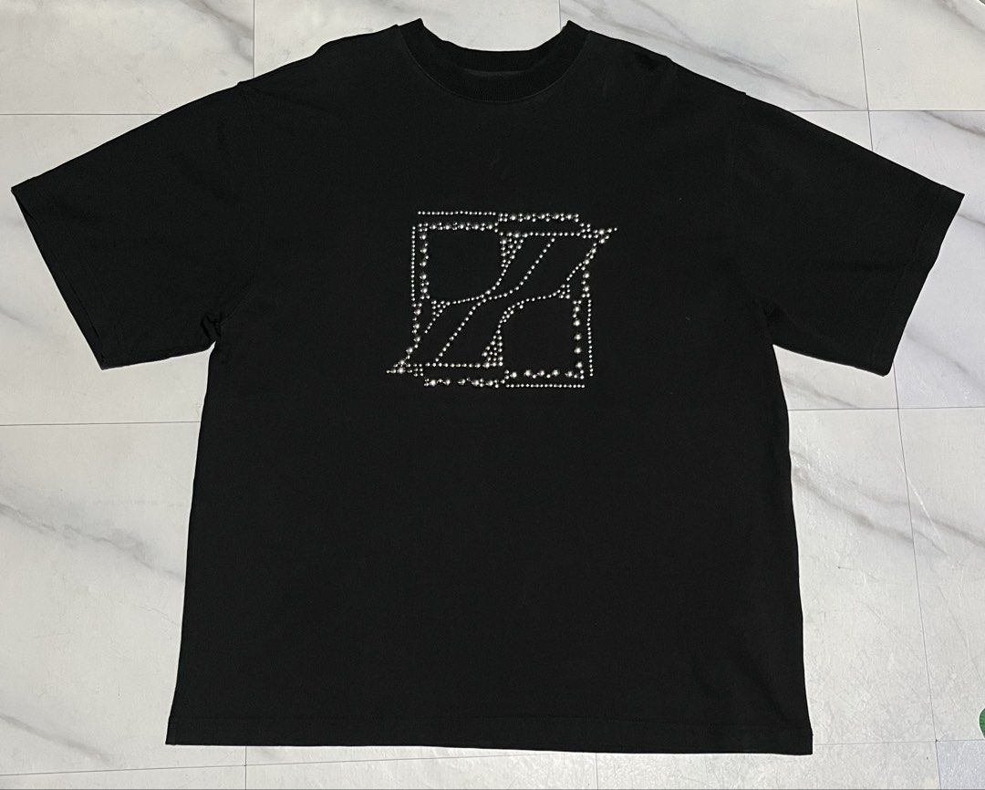 We11done Studded Graphic Black T-Shirt (Category: Formal Shirts) located in Cavite. Submitted by christianzuuu (Listing ID 1465728213, Image 1). Description: - Dimes on actual photo - Brand: We11done - Color: Black - Fit: Classic crewneck, relaxed boxy cut - Details: Metal stud graphic on the chest - Material: Heavy cotton fabric - Condition: Clean overall - Measurements: 26.5 x 21.5 inches (from taped tag) - Authenticity: Interior collar tag and