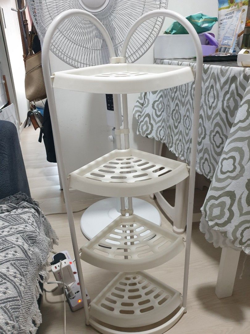 White 4-tier corner shelf storage rack (Category: Shelves, Cabinets & Racks) located in Paranaque City. Submitted by gummy_008 (Listing ID 1465630384, Image 1). Description: - Color: White - 4-tier corner design saves space in bathrooms, kitchens, or bedrooms - Sturdy metal frame with lightweight plastic shelves - Ideal for organizing toiletries, books, or small plants - Clean, compact, and easy to assemble.