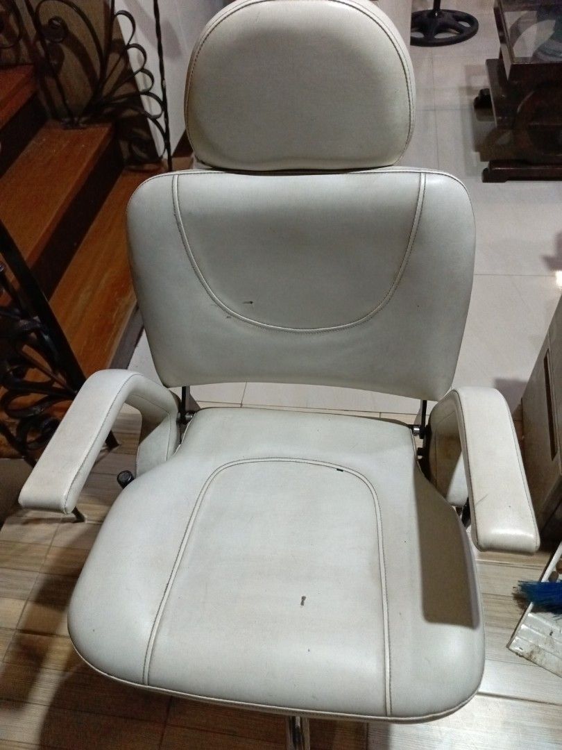 White Adjustable Salon Chair with Headrest (Category: Chairs) located in San Juan City. Submitted by pinkdenxel (Listing ID 1465704016, Image 1). Description: - Color & Material: White synthetic leather - Features: Separate adjustable headrest, padded armrests, and built-in height adjustment - Condition: Fully functional and sturdy frame with minor scuffs/marks on upholstery - Ideal for: Salon, office, or study setup.