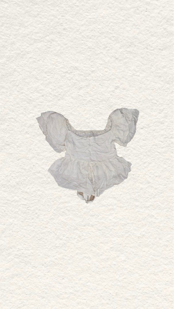 White baby romper with short puff sleeves (Category: Blouses) located in Quezon City. Submitted by zealhorse_a9f3c3 (Listing ID 1465620781, Image 1). Description: - Color: White - Style: Infant romper with flared waist and short puff sleeves - Neckline: Trendy square neckline - Convenience: Bottom snap closures for quick and hassle-free diaper changes - Material: Soft, baby-friendly fabric for all-day comfort - Use: Versatile and simple piece for