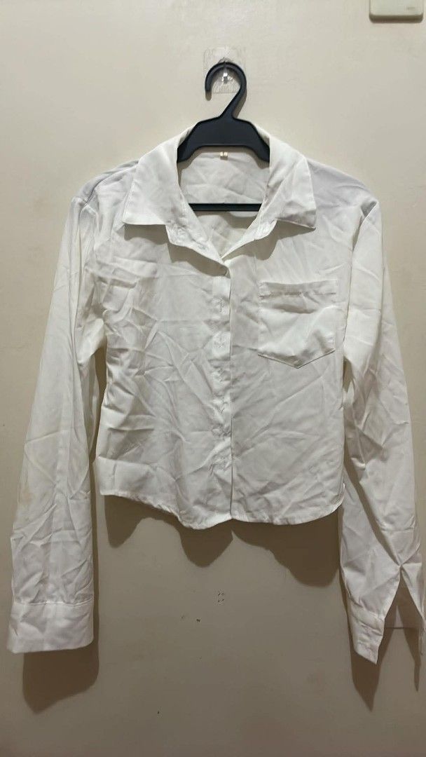 White Button-Up Long Sleeve Crop Shirt (Category: Longsleeves) located in Tanauan. Submitted by fiercebird_3f5fa9 (Listing ID 1465759078, Image 1). Description: - Color: Classic White - Fit: Trendy cropped fit - Details: Long sleeves, chest pocket, regular collar, and front button closure - Style: Simple and plain design that goes with everything - Versatility: Easy to dress up for work or dress down for casual days.