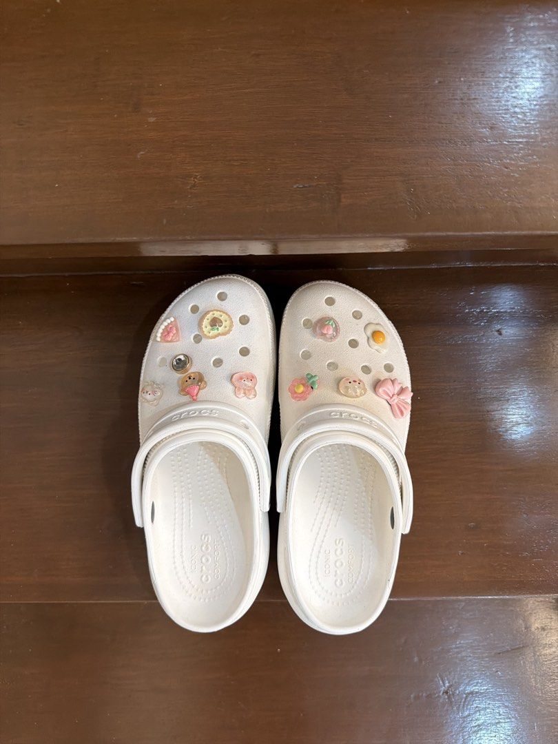 White Crocs Classic Clog Platform with Jibbitz charms (Category: Slippers and slides) located in San Juan City. Submitted by hazeldee (Listing ID 1465718158, Image 2). Description: - Color/Style: White platform classic clog - Inclusions: Comes with cute Jibbitz charms (fried egg, pink bow, bear, and food items) - Features: Slip-on design with pivoting heel straps & Iconic Crocs Comfort footbed - Condition: Excellent 100% Authentic with Crocs Offi