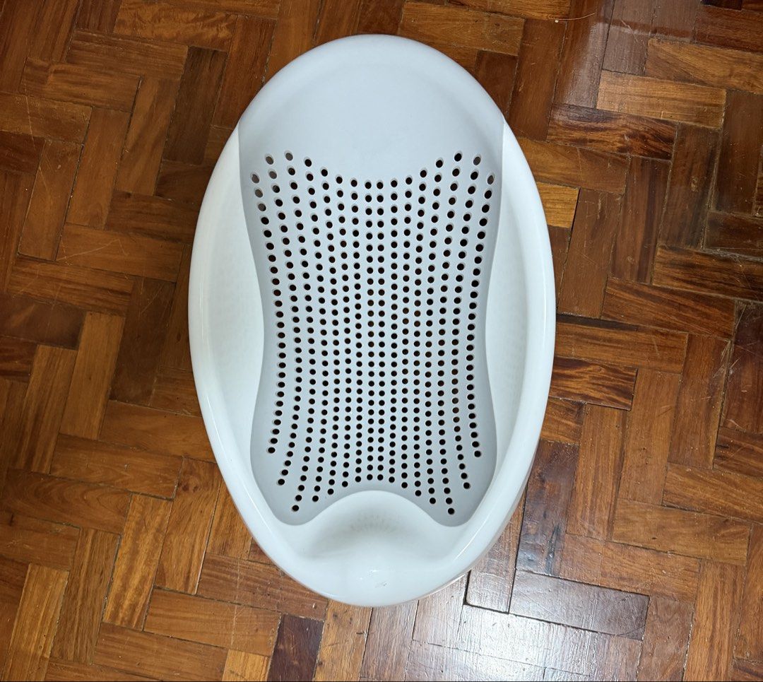 White ergonomic baby bath support seat (Category: Bathtub & Bath Accessories) located in Manila. Submitted by babystuffmnl (Listing ID 1465666190, Image 1). Description: - Ergonomic baby bath support seat in white - Perforated mesh design for fast water drainage and comfort - Smooth contours for safe infant support - Convenient side cut-outs for easy handling - Sturdy, durable plastic construction for daily use - Clean, sanitized, and ready for y