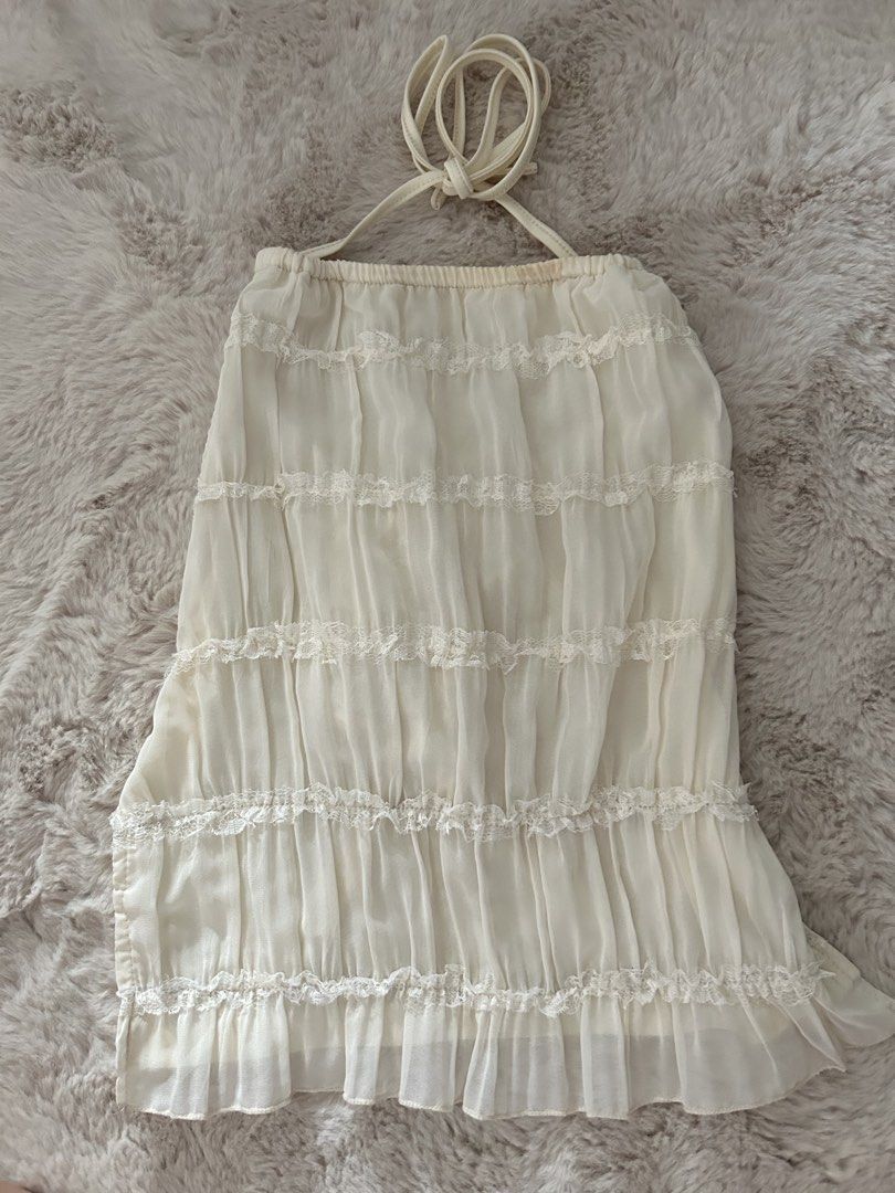 white lace trim backless halter neck ruched top (Category: Sleeveless) located in San Juan City. Submitted by ilovekitaro (Listing ID 1465590791, Image 1). Description: - super pretty - perfect for the beach ! - backless with ties at the back - used once - has a small makeup stain RFS : not my style anymore mop : gcash only mod : lalamove, j&t, ggx loc : san juan city metro manila.