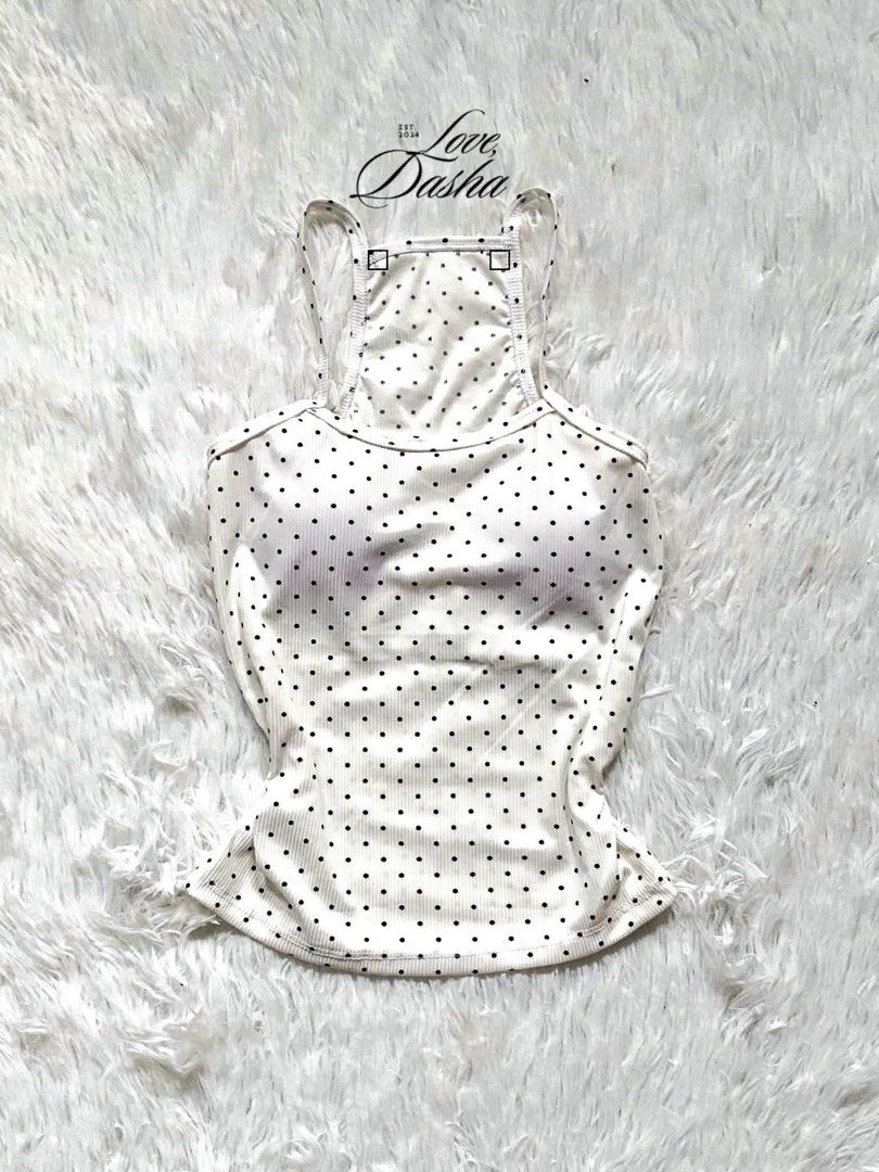 White Polka Dot Ribbed Padded Tank Top (Category: Sleeveless) located in Manila. Submitted by lovedasha.ph (Listing ID 1465603219, Image 1). Description: - Design: White ribbed tank top with cute black polka dots - Comfort: Built-in chest padding (no bra needed!) - Fit: Fitted torso with a slightly flared hem and stretchy cotton-blend fabric - Style: Racerback with thin shoulder straps - Condition: Great wardrobe staple for warm weather.