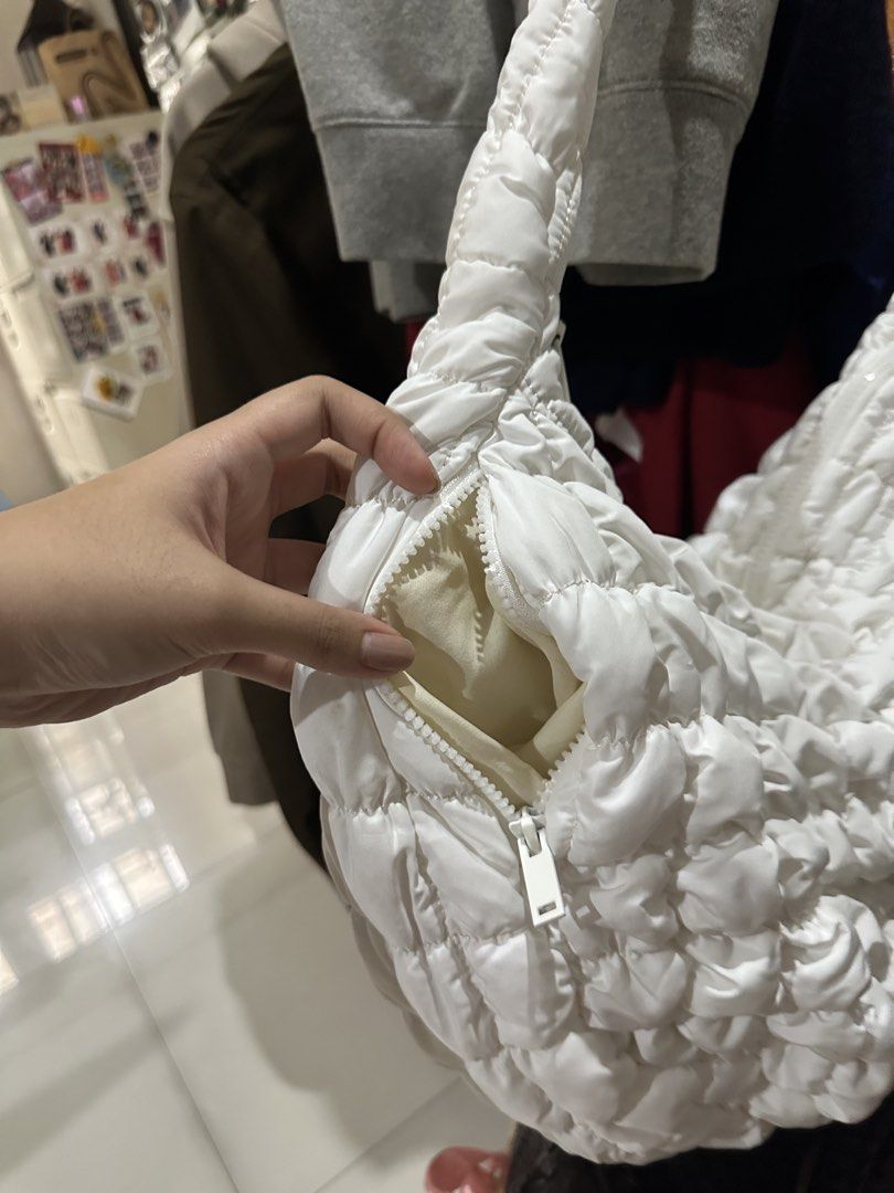 White Puffer Cloud Shoulder Bag Quilted Hobo (Category: Shoulder Bags) located in Quezon City. Submitted by cassie.u (Listing ID 1465639369, Image 2). Description: - Color & Style: White quilted puffer bag with a soft cloud texture and neutral match-all design - Closure: Secure zip top closure - Storage: Includes 2 handy inner zippered pockets for small essentials - Strap: Thick, comfortable ruched shoulder strap - Material: Lightweight and ideal