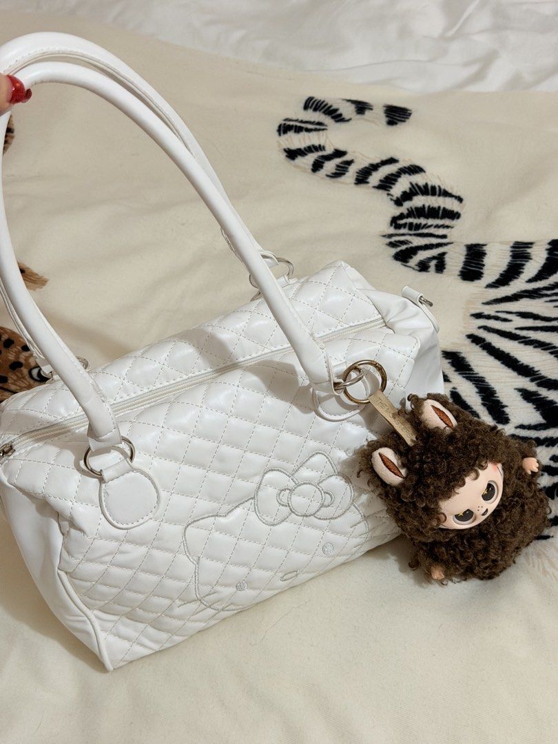 White Quilted Hello Kitty Shoulder Bag with Labubu Plush (Category: Shoulder Bags) located in Manila. Submitted by mengxir20193848 (Listing ID 1465719268, Image 3). Description: - Color: White with chic quilted design - Design: Kitty embroidered outline on the front - Versatility: Includes double top handles and a detachable shoulder strap - Interior: Clean fabric lining with a convenient zipper pocket and roomy space for daily essentials - Bonus