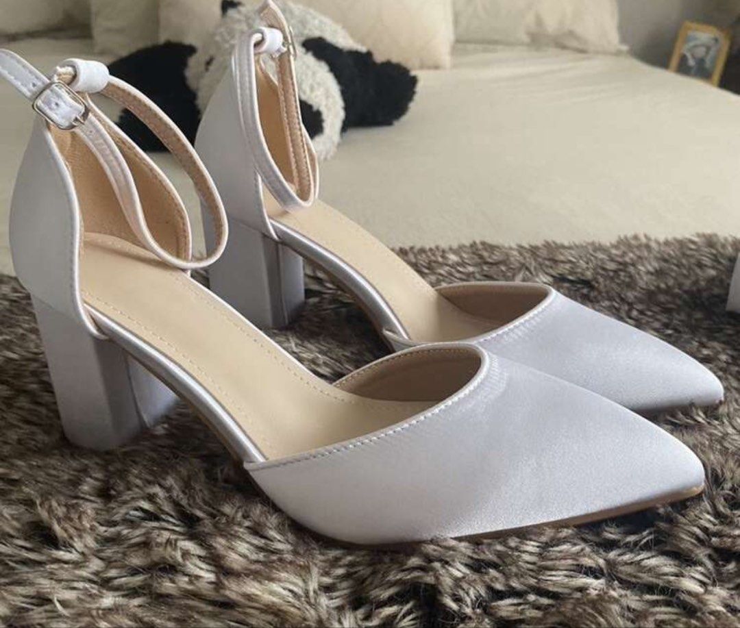 White Satin Block Heel Wedding Shoes Ankle Strap (Category: Heels) located in Dagupan City. Submitted by vallureph (Listing ID 1465591419, Image 2). Description: - Style: White satin heels with pointed toe and chunky block heel - Details: Delicate ankle strap with silver buckle closure - Height: Comfortable mid-height heel - Condition: Worn once for a wedding, clean soles, and spotless upper material - Perfect for: Weddings, debuts, and special o