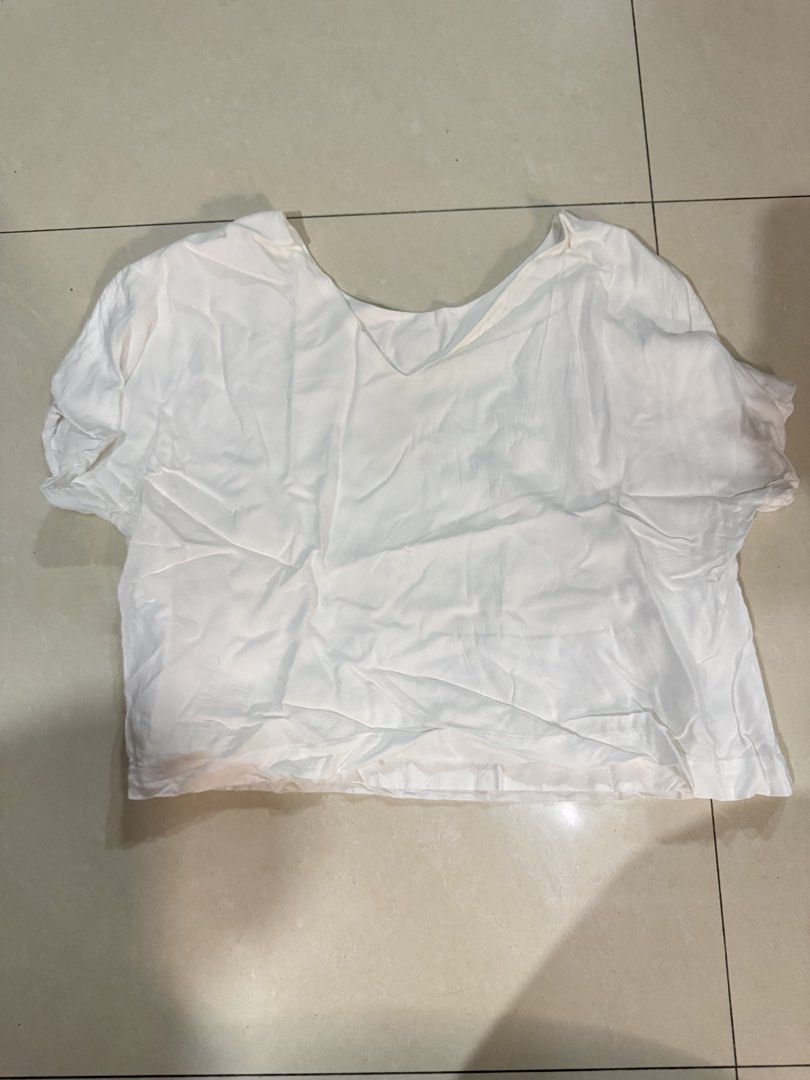 White Short Sleeve V-Neck Crop Top (Category: Shirts) located in Quezon City. Submitted by sweetlyluxe (Listing ID 1465625112, Image 1). Description: - fits up to M - Color: Plain White - Style: V-neck crop top with short sleeves - Lining: Features a layered inner lining for extra coverage - Fabric: Lightweight and breezy - Pairing: Perfect with high-waisted jeans or skirts - Condition: Clean and ready to wear.
