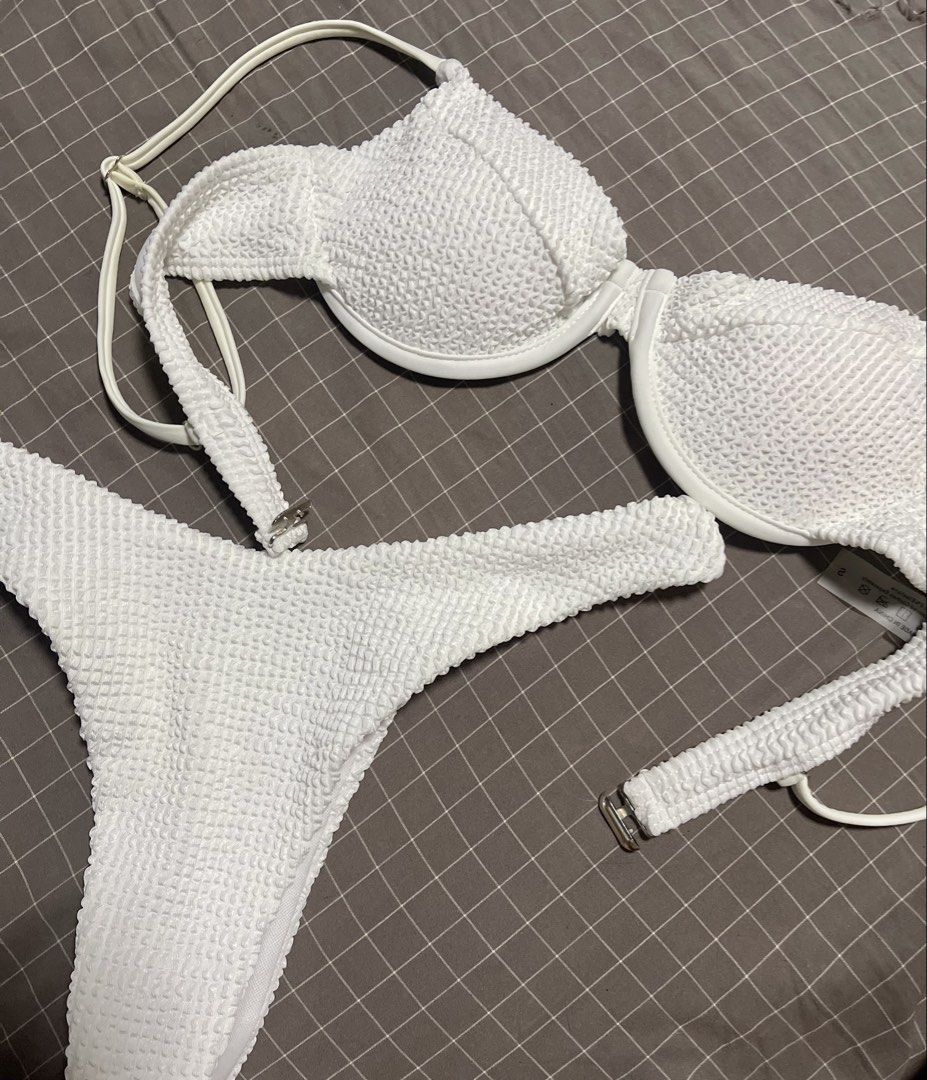 White textured crinkle bikini set two-piece swimsuit (Category: Bikinis & Swimsuits) located in Calamba. Submitted by goldenprngs101 (Listing ID 1465688736, Image 1). Description: - Style: Two-piece bikini - Color: White with trendy crinkle texture - Size: Small, 32A - Top: Underwire support, adjustable shoulder straps, and back clasp closure - Bottoms: Flattering high-leg cut - Material: Polyester and elastane - Condition: Clean, excellent, and 