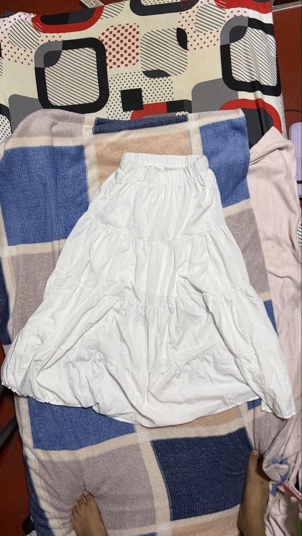White Tiered Maxi Skirt (Category: Skirts) located in Quezon City. Submitted by e182885da6246a5b75aac67add07a3 (Listing ID 1465629245, Image 1). Description: - Color: Classic White - Design: Tiered with multiple layered ruffles - Waistband: Comfortable elastic waistband, pull-on style - Fabric: Lightweight and breathable - Styling: Pairs easily with casual tees and blouses.
