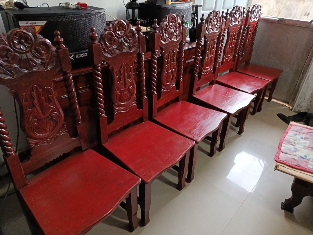 Wooden dining table set with 6 carved chairs (Category: Tables & Sets) located in Manila. Submitted by jj_john13 (Listing ID 1465612413, Image 3). Description: - Set includes: 1 oval dining table and 6 matching chairs - Material: Narra wood with a deep reddish-brown finish - Design: Intricate carved floral details and spiral twisted side posts on chair backs - Table details: Features a beautifully carved decorative edge trim - Build: Sturdy, dura