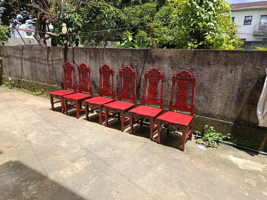 Wooden dining table set with 6 carved chairs (Category: Tables & Sets) located in Manila. Submitted by jj_john13 (Listing ID 1465612413, Image 2). Description: - Set includes: 1 oval dining table and 6 matching chairs - Material: Narra wood with a deep reddish-brown finish - Design: Intricate carved floral details and spiral twisted side posts on chair backs - Table details: Features a beautifully carved decorative edge trim - Build: Sturdy, dura