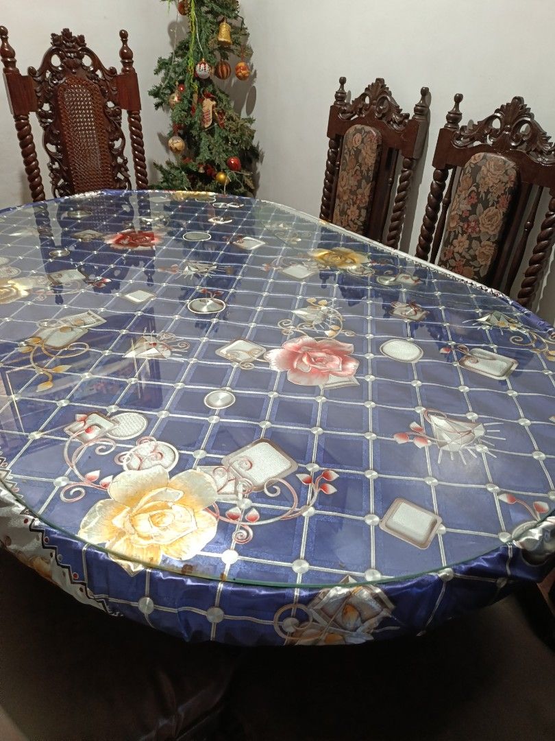 Wooden Dining Table Set with Chairs (Category: Tables & Sets) located in Manila. Submitted by jj_john13 (Listing ID 1465631081, Image 2). Description: - Solid wood dining set with heavy, sturdy build - Includes oval glass-topped table and 4 matching chairs - Chairs feature comfortable cushioned seats and intricate high carved backs - Normal wear on wood frames from regular household use - Selling as a complete set - Great statement piece for larg