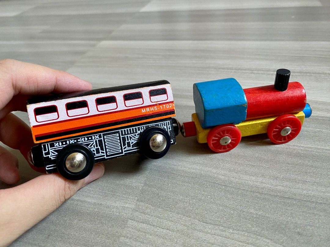 Wooden Toy Train Set with Engine and Carriages (Category: Kids Toys) located in Bauang. Submitted by tinyhandspreloved (Listing ID 1465714925, Image 2). Description: - TAKE ALL -Wooden toy train set with a colorful locomotive and carriages - Smooth-rolling wheels for fun floor play - Compatible with standard wooden railway tracks - Condition: Minor paint chipping on edges from regular play - Great addition to any child's toy collection.