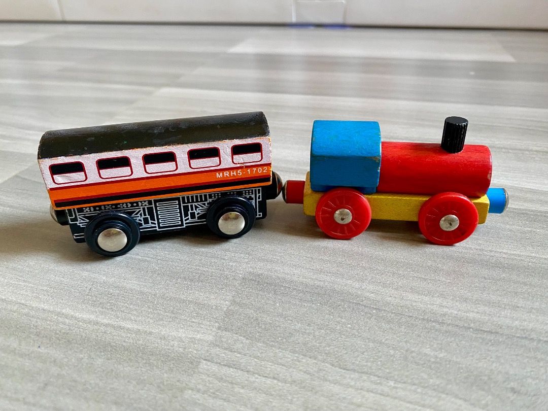 Wooden Toy Train Set with Engine and Carriages (Category: Kids Toys) located in Bauang. Submitted by tinyhandspreloved (Listing ID 1465714925, Image 3). Description: - TAKE ALL -Wooden toy train set with a colorful locomotive and carriages - Smooth-rolling wheels for fun floor play - Compatible with standard wooden railway tracks - Condition: Minor paint chipping on edges from regular play - Great addition to any child's toy collection.