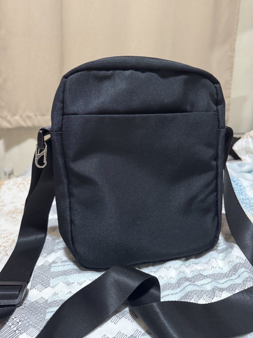 World Traveller Sling Bag Fits Ipad (Category: Sling Bags) located in Manila. Submitted by micbri (Listing ID 1465723454, Image 2). Description: World Traveller Crossbody/ Sling Bag - Color: Classic black - Material: Durable, high-quality fabric - Compartments: Multiple zippered compartments for secure storage - Interior: Stylish grey lining with organizational pockets and branded patch - Exterior: Convenient front zip pocket and rear slip pocket