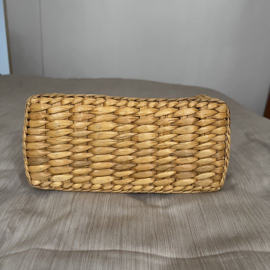 Woven Straw Handbag Structured Top Handle Basket Bag (Category: Beach Bags) located in Pasig City. Submitted by jenscloset86 (Listing ID 1465703700, Image 3). Description: • Natural woven straw handbag with a rigid structured shape and flat rectangular base. • Normal wear in one handle due to usage. • Double braided top handles with decorative knot accents and an open top. • Lightweight, easy to carry. • Perfect for summer! Measurement (in inches