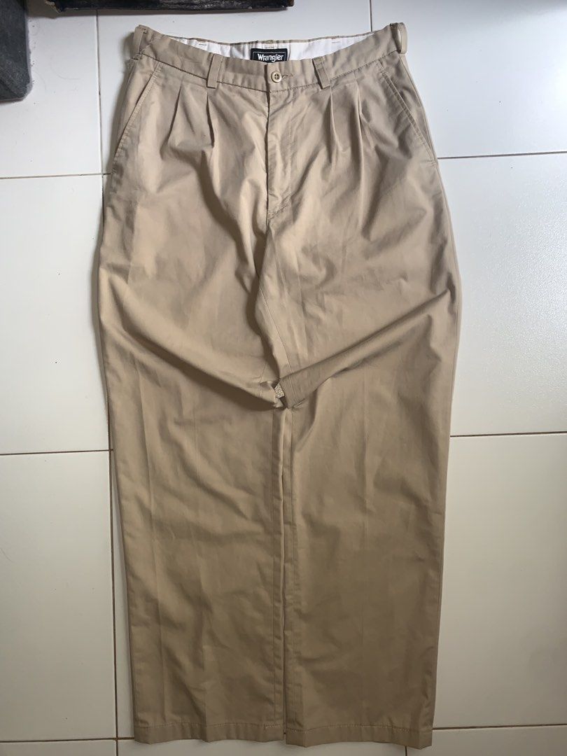 Wrangler Khaki Pleated Trousers (Category: Trousers) located in Mataasnakahoy. Submitted by grailsph.81630 (Listing ID 1465747591, Image 1). Description: - Brand: Wrangler - Style: Pleated trousers / Straight cut - Color: Khaki beige - Origin: Made in Greensboro, NC, U.S.A. - Details: Classic front pleats, belt loops, button closure, clean white inner waistband - 30”-31”W x 39”-40”L - Condition: Great vintage staple piece - Best for: Casual to sm